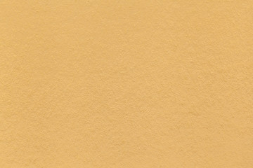 Texture of old light yellow paper closeup. Structure of a dense cardboard. The golden background