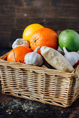 Citrus fruits with ginger roots inside basket.