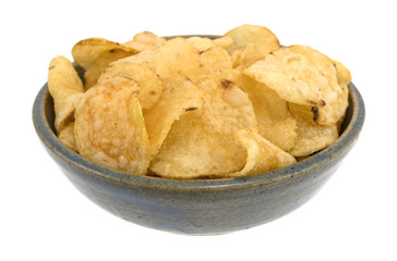 Bowl of salt and vinegar flavored potato chips isolated on a white background.