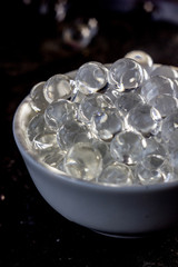 Hydrogel balls on white bowl.