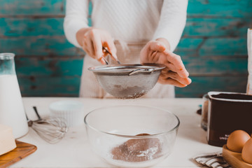 House wife wearing apron making. Steps of making cooking chocolate cake.