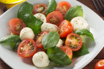 caprese salad in plate at wood