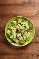 caesar salad in plate at wood