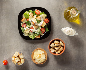 caesar salad and ingredients at table