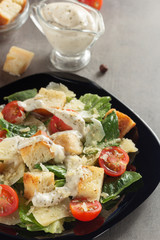 caesar salad and ingredients at table