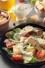 caesar salad and ingredients at table