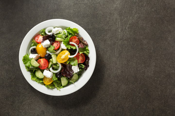 fresh greek salad in plate on stone