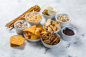 Salty beer snacks in whit bowls