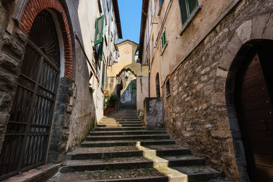 Narrow streets of authentic Bellano fishing village, situated on Como Lake shore. Traditional italian houses, stone steps and arcway  in small town Bellano, Lombardy, Italy.