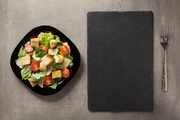 caesar salad in plate at table