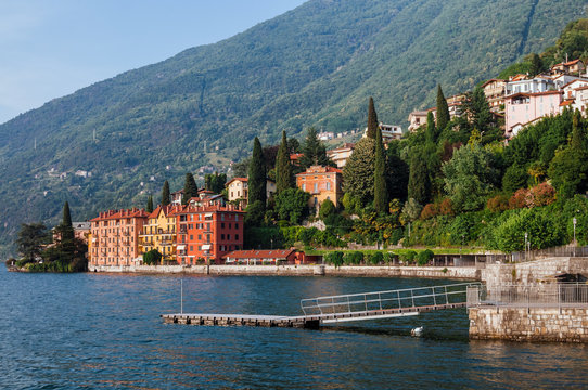  Coastline of Bellano fishing village, situated on Como Lake shore, Lombardy, Italy. Traditional italian houses, mountains and pier in small coast town Bellano.