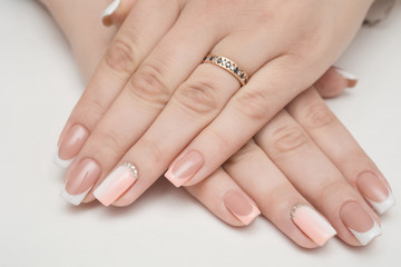 Manicure - Beauty treatment photo of nice manicured woman fingernails. Very nice feminine nail art with nice pink, gold and black nail polish.