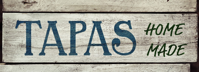 text tapas homemade in a rustic signboard