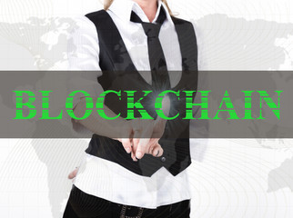 businesswoman in a jacket and tie pressing blockchain button of a virtual screen. exchange and production of crypto currency concept