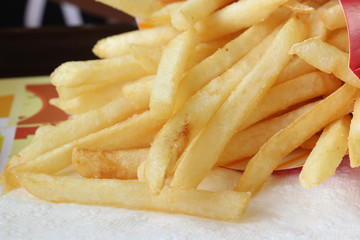 French fries on white tissue, close up shot