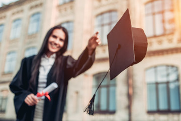 Female graduate near university