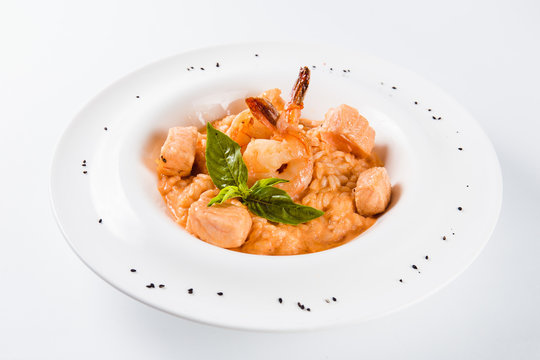 Risotto with shrimp and salmon in a mild creamy sauce (close)