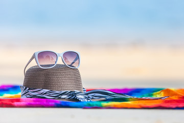 sunglasses and Beach hat on the beach