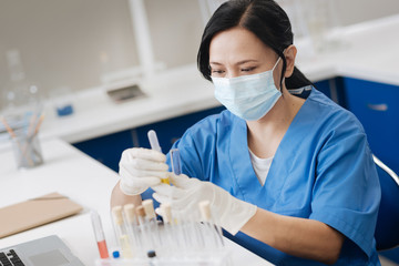 Professional lab working wearing a surgical mask