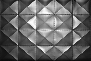 Embossed square metal tiles on a wall