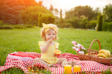 Little girl enjoying fruits on picnic