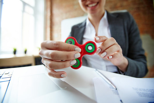 Businesswoman with fidget spinner having anti-stress timeout