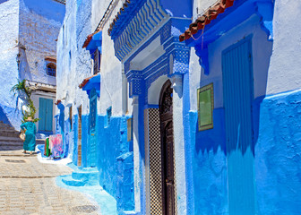 Fototapeta na wymiar Street and building at Chefchaouen, the blue city in the Morocco. Old traditional town. Travel destination concept. Architectural decoration and design details.