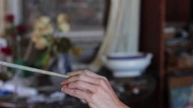The hand with the artist's brush closeup