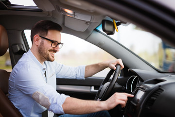 Man using navigation system while driving car