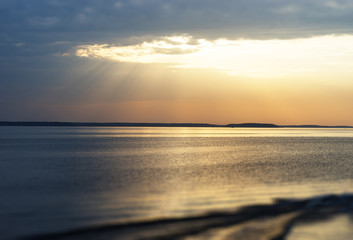 Sunset rays over the ocean with boat trace background
