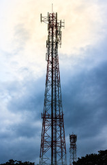 Communication tower with blue sky and cloud.