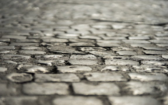 Fototapeta Old roman stone pavement in the downtown of Rome, Italy. June 20