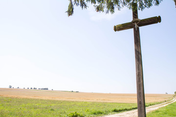Wooden cross at a crossroad