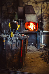Fire in the furnace in the smithy, tools