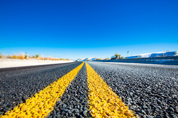 Yellow stripes on asphalt road