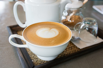 cappuccino cup of coffee with teapot and sugar
