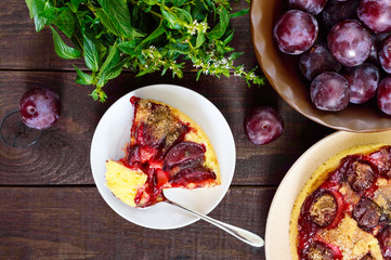 A piece of plum pie  on a dark wooden background. American traditional pastries.