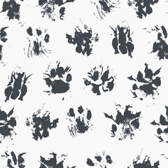 Abstract seamless pattern - black ink prints with messy cat paws. © lumitar