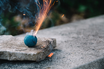 Blue smoke bomb blowing sparks