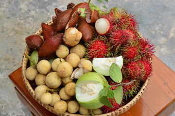 Longkong, dragonfruit, rambutan and guava in a woven basket