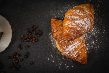 Croissant with sugar and coffee