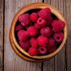 Berry Fresh in a wooden bowl on a vintage background. Raspberry.Food or Healthy diet concept.Super Food.Vegetarian.selective focus.