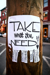 Street art poster on a wooden street light giving you courage, wisdom, passion,strength, peace, understanding, kindness or clarity
