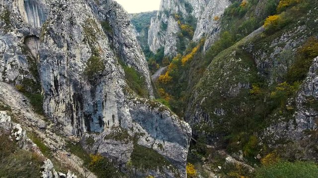 4k aerial drone flying backwards over Turda Gorge nature reserve, Romania.	Turda Gorge nature reserve contains one of the richest and most scenic karst landscapes in Romania. 
