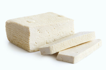 Block of white tofu and two slices isolated on white.