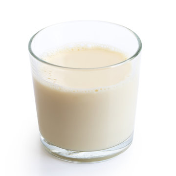 Glass of soya milk with froth isolated on white.