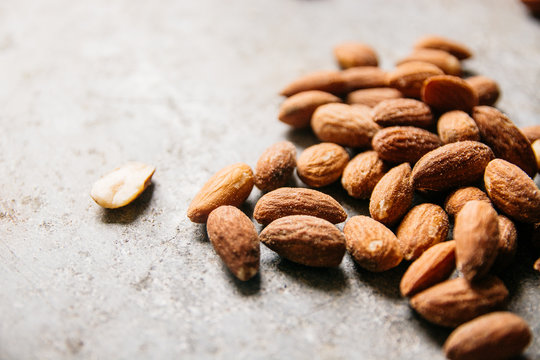 Almond seeds on a stone surface