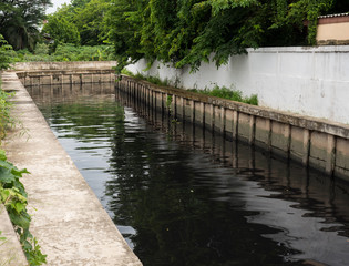 water in black color at  canal concrete