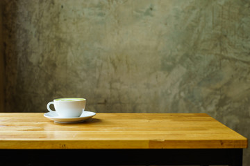 white coffee cup and saucer on a wooden background