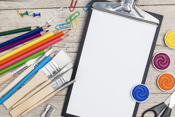 school accessories on a light wooden background